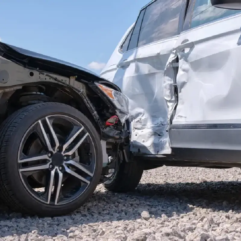 T-bone car crash scene showing significant damage to the side of a white vehicle and the front of a black vehicle, illustrating the dangers of side-impact collisions in Texas.