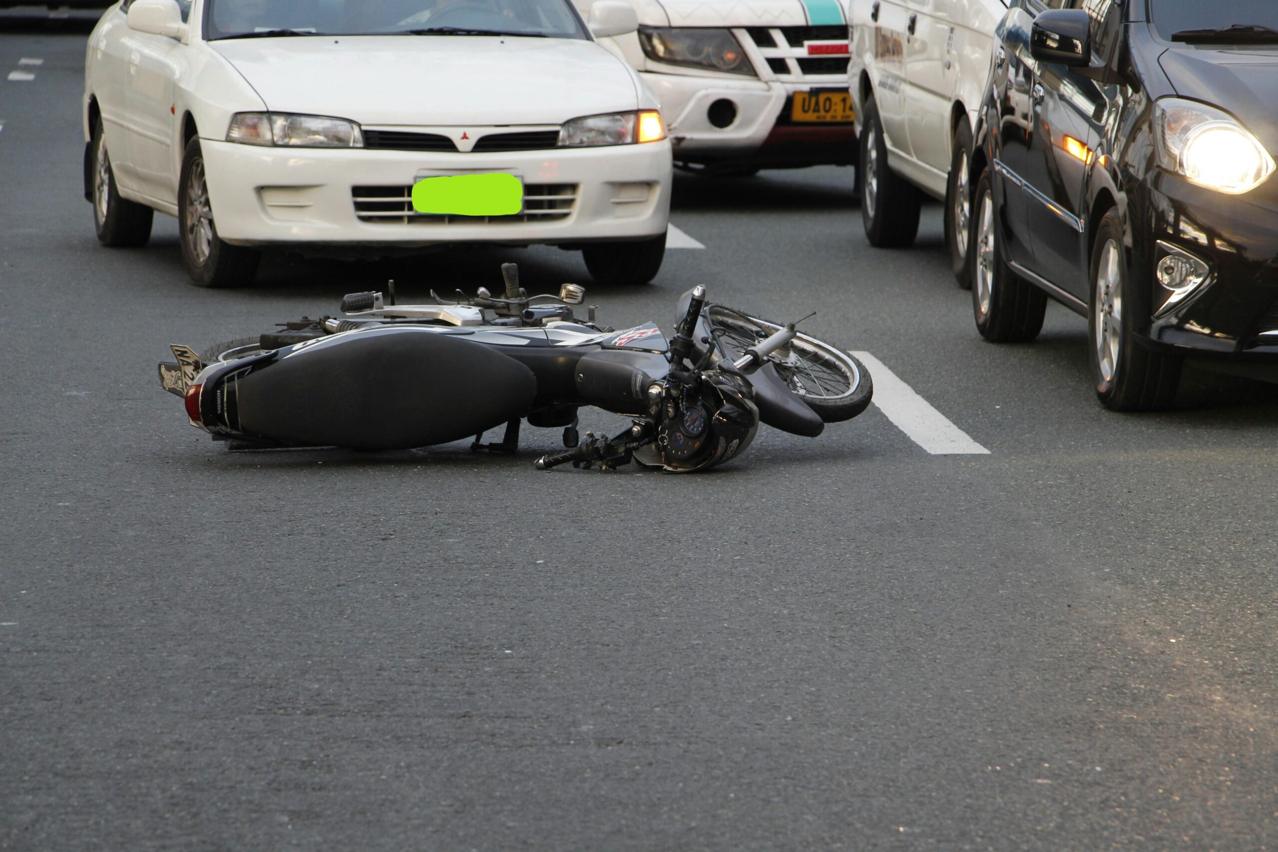 Motorcycle accident on a busy road, highlighting the risks faced by motorcyclists in personal injury cases in Shavano Heights.