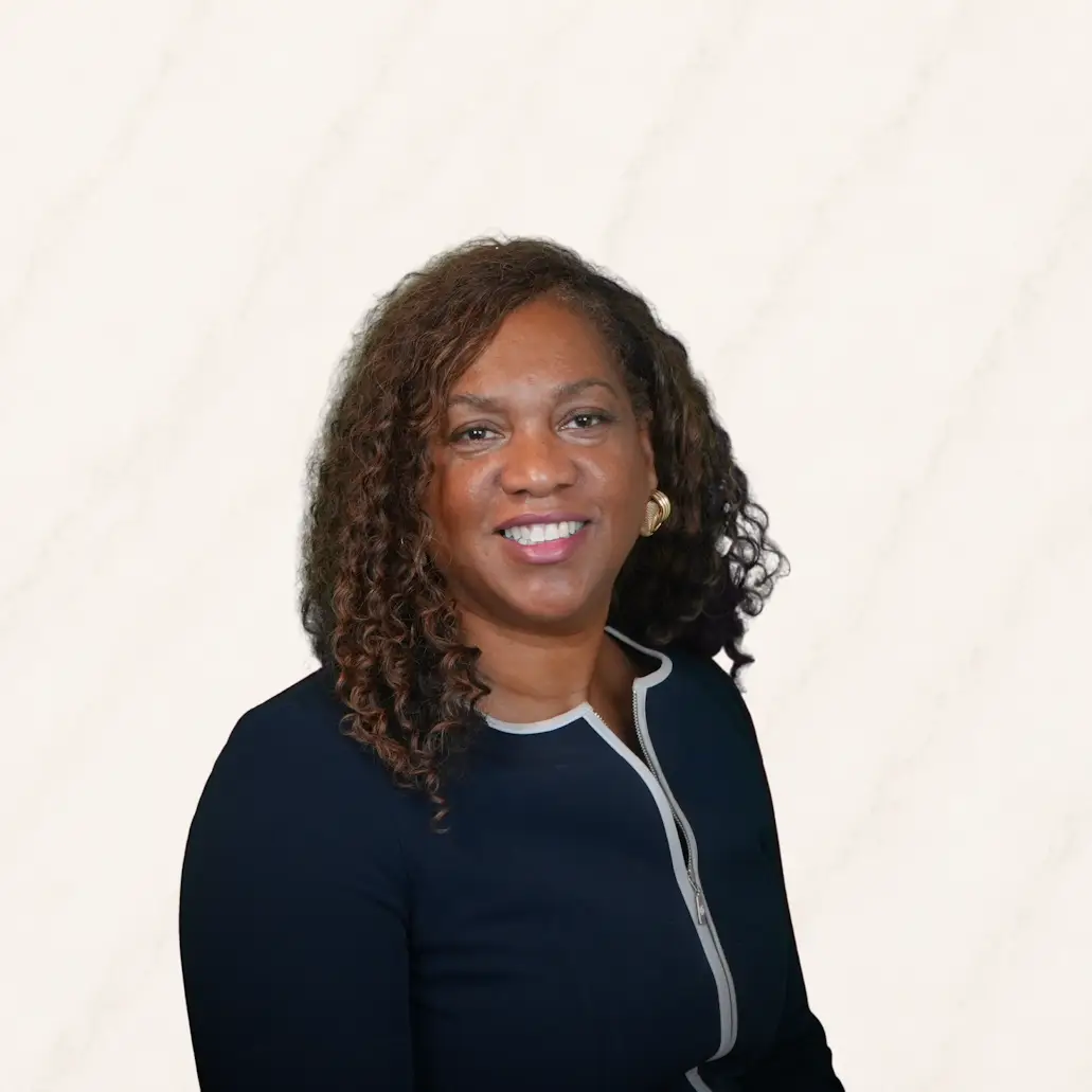 Professional headshot of Cheryl Coleman Driver wearing glasses and a navy blazer